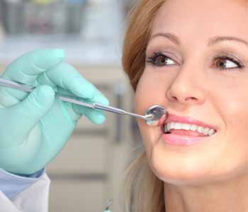 dentist restores smiles with biocompatible dental implants